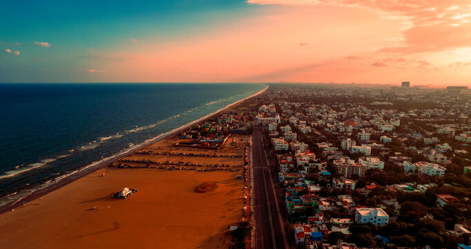 Marina Beach at sunrise with visitors enjoying the calm waves in Chennai.